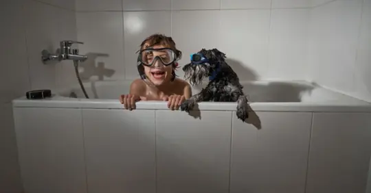 Kid bathing with dog