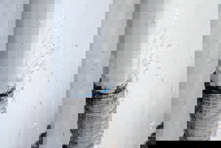 pipe spurts water from a crack