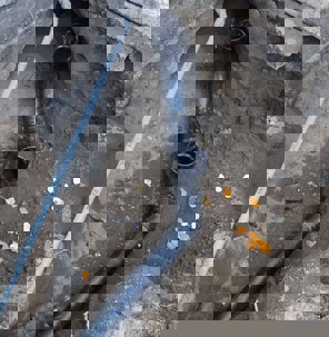 Drainage pipes sit in a ditch