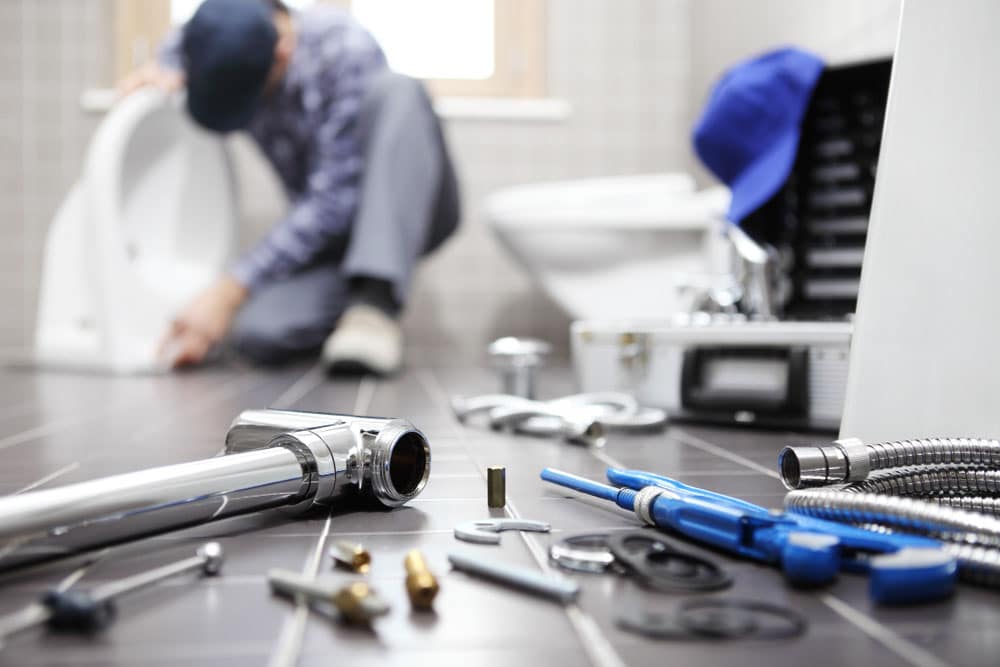 Person doing makeshift plumbing repairs